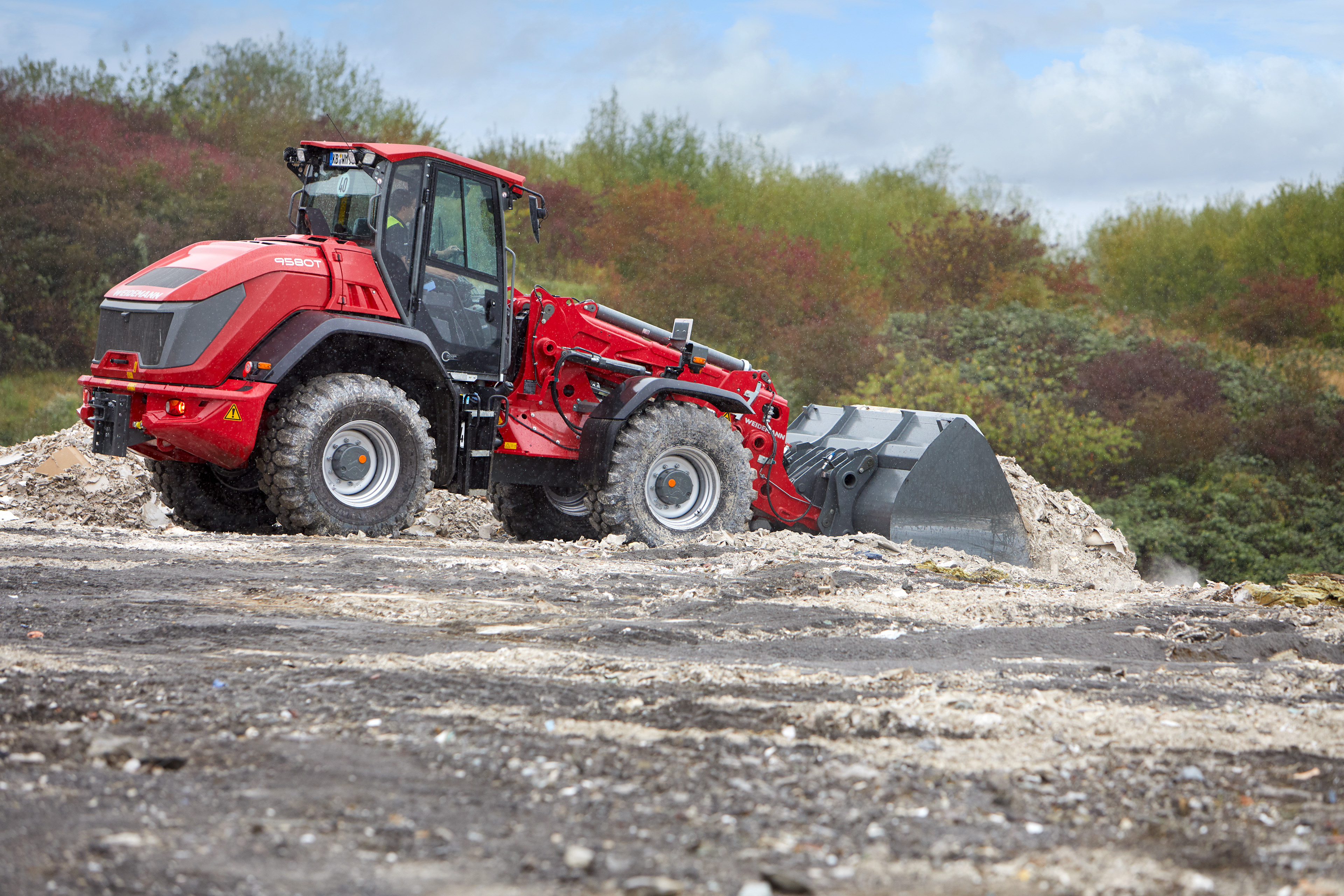 Weidemann tele wheel loader 9580T in use with earth bucket in recycling operation