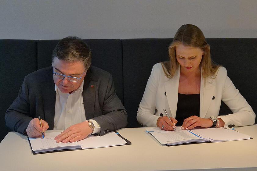 Two persons signing a contract