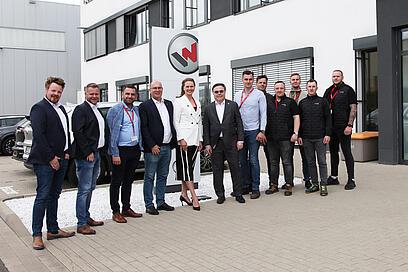 group of people standing in front of a building